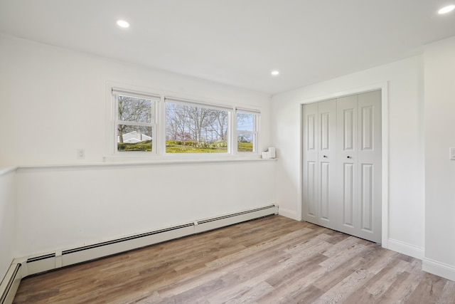 2 Benson Dr, Danbury, CT 06810 - unfurnished bedroom featuring a baseboard heating unit, light wood-style floors, baseboards, and recessed lighting