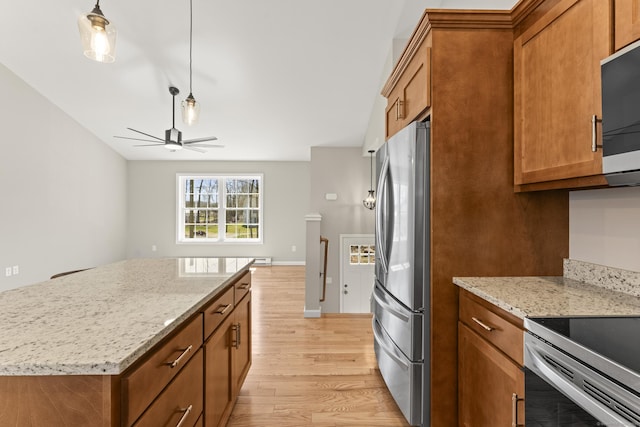kitchen with freestanding refrigerator, light wood-style flooring, ceiling fan, and brown cabinetry