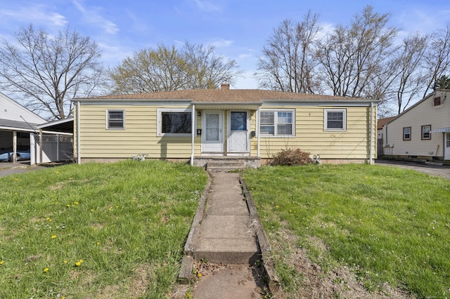 view of front of home with a front yard and a chimney