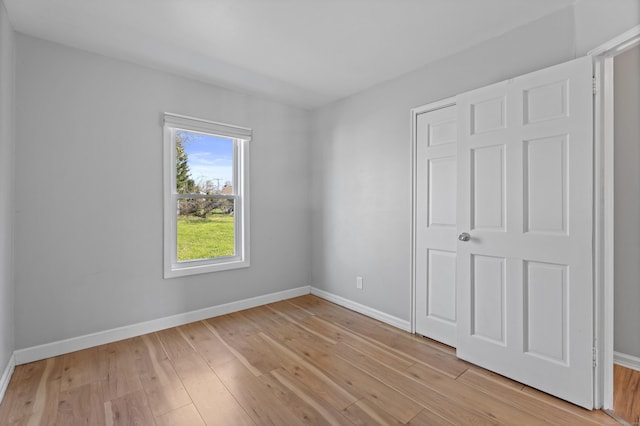 unfurnished bedroom featuring baseboards and light wood-style flooring