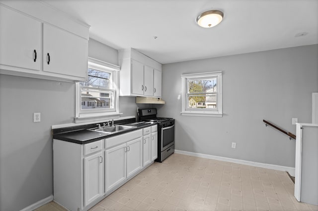 kitchen featuring white cabinets, a wealth of natural light, stainless steel gas range, and a sink