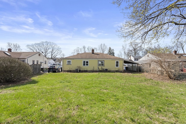 rear view of house featuring fence, crawl space, a chimney, and a yard