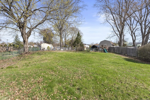 view of yard featuring a fenced backyard and a playground