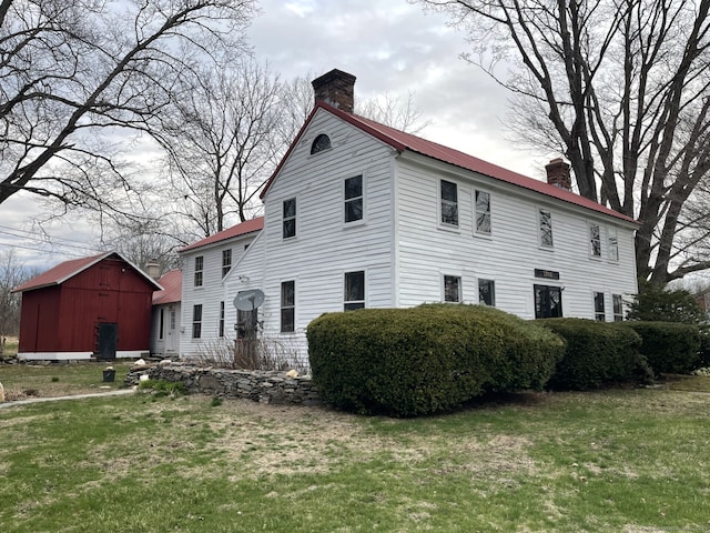 1156 Exeter Rd, Lebanon, CT 06249 - view of property exterior with a lawn, a chimney, an outbuilding, and metal roof