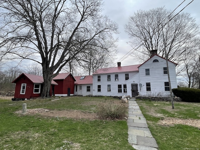 1156 Exeter Rd, Lebanon, CT 06249 - view of front of property with a front lawn, a chimney, and metal roof