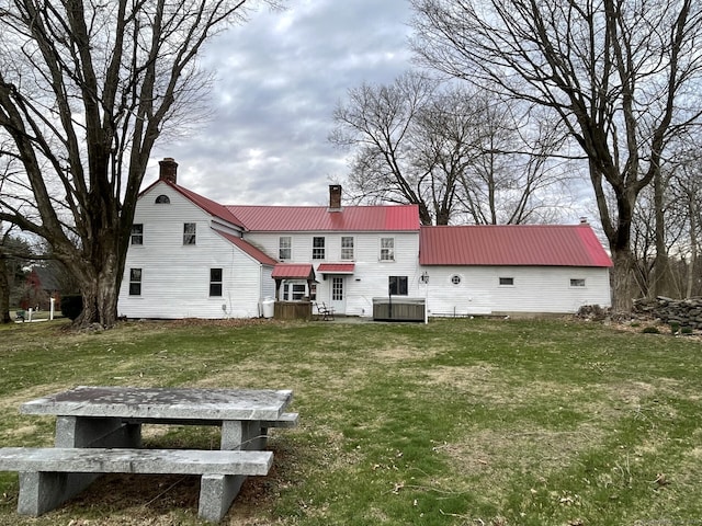 1156 Exeter Rd, Lebanon, CT 06249 - back of property featuring a lawn, a chimney, central AC, and metal roof
