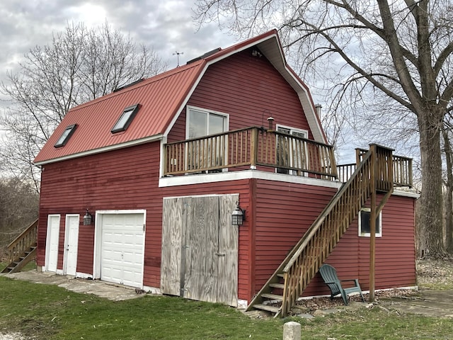 1156 Exeter Rd, Lebanon, CT 06249 - back of property with a gambrel roof, a deck, stairs, and metal roof