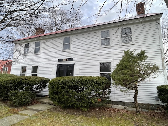 1156 Exeter Rd, Lebanon, CT 06249 - back of property featuring a chimney and metal roof