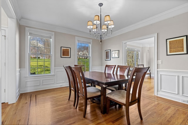 10 Granite Rd, New Milford, CT 06776 - dining space with a wainscoted wall, a notable chandelier, light wood finished floors, and plenty of natural light