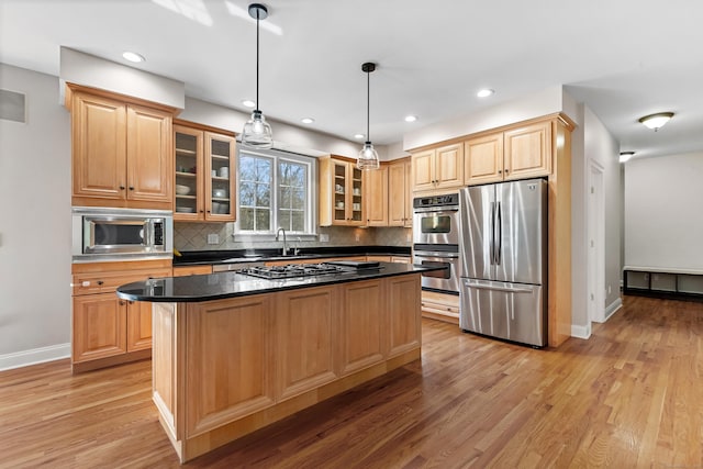 10 Granite Rd, New Milford, CT 06776 - kitchen featuring a center island, tasteful backsplash, light wood finished floors, baseboards, and appliances with stainless steel finishes