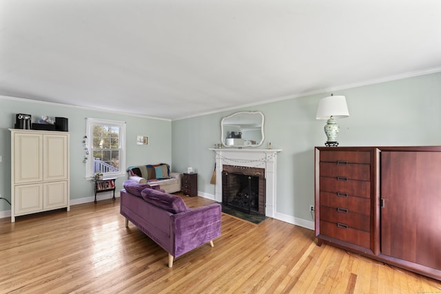 11 Knollwood Dr, Newtown, CT 06470 - living area featuring crown molding, light wood finished floors, a brick fireplace, and baseboards