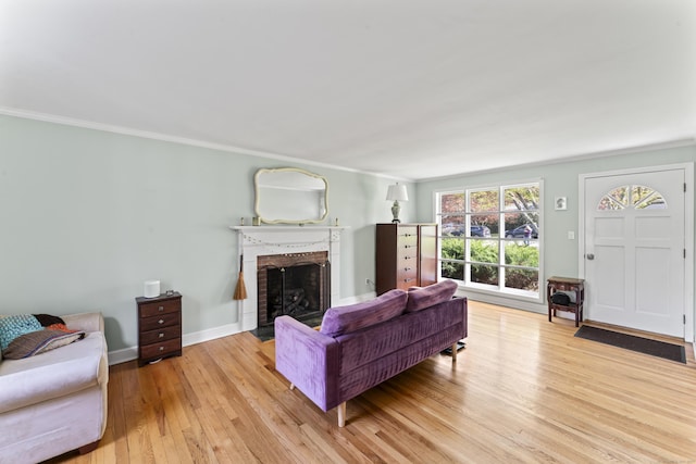 11 Knollwood Dr, Newtown, CT 06470 - living room with baseboards, ornamental molding, a brick fireplace, and light wood finished floors
