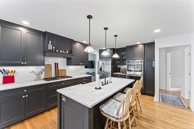 11 Knollwood Dr, Newtown, CT 06470 - kitchen featuring a sink, decorative backsplash, a kitchen breakfast bar, and stainless steel appliances