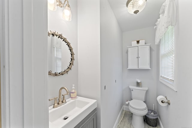 11 Knollwood Dr, Newtown, CT 06470 - half bath featuring baseboards, vanity, toilet, and marble finish floor