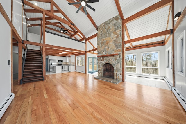 unfurnished living room with a fireplace, ceiling fan, high vaulted ceiling, and a baseboard heating unit
