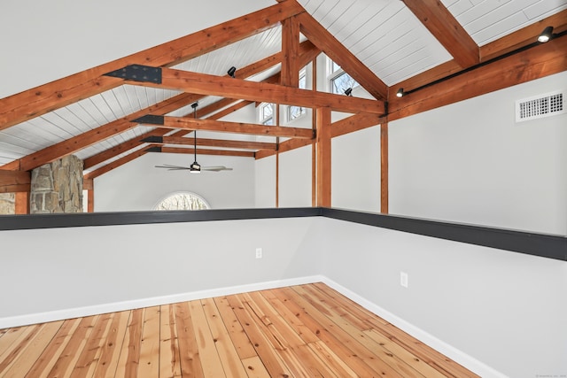 interior space with lofted ceiling with beams, ceiling fan, visible vents, baseboards, and hardwood / wood-style floors
