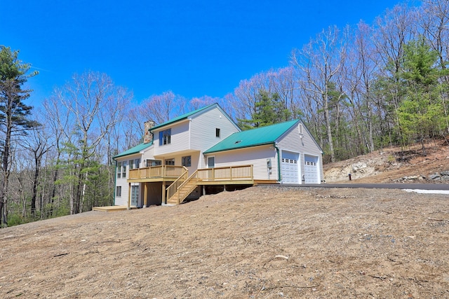 254 Wright Rd, Canton, CT 06019 - back of property with stairway, a chimney, a wooden deck, and a metal roof