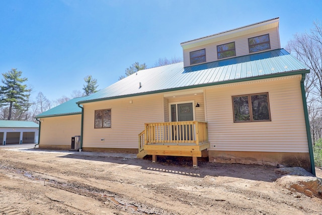 view of front of home featuring an outbuilding and metal roof