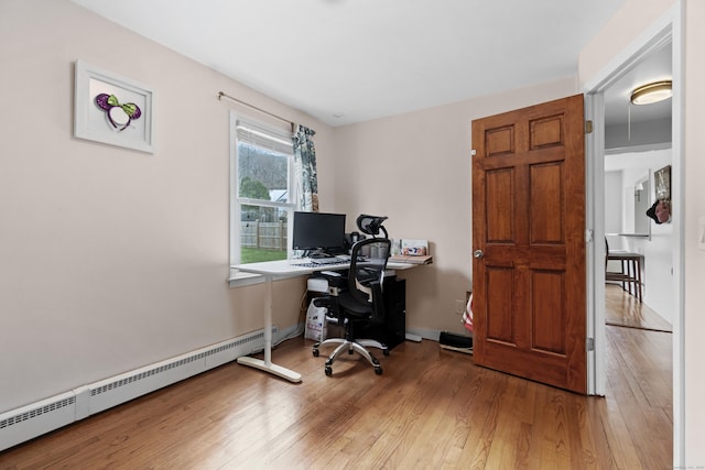 office space featuring baseboard heating and wood finished floors