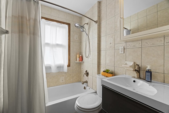 bathroom featuring toilet, vanity, tile walls, tasteful backsplash, and shower / bath combo