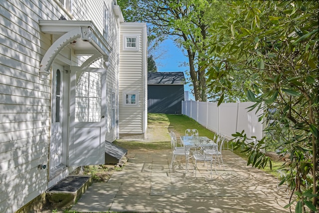 view of patio with fence and outdoor dining space