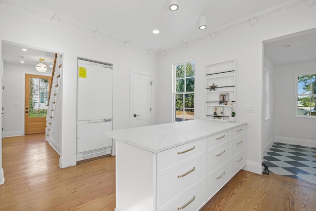 kitchen with recessed lighting, light countertops, white cabinetry, and a peninsula