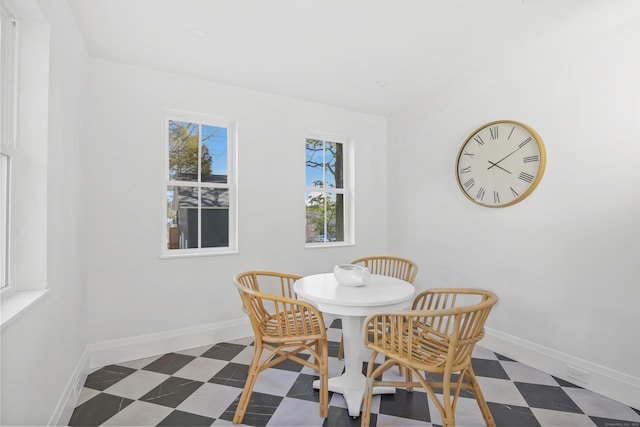 dining area featuring tile patterned floors and baseboards