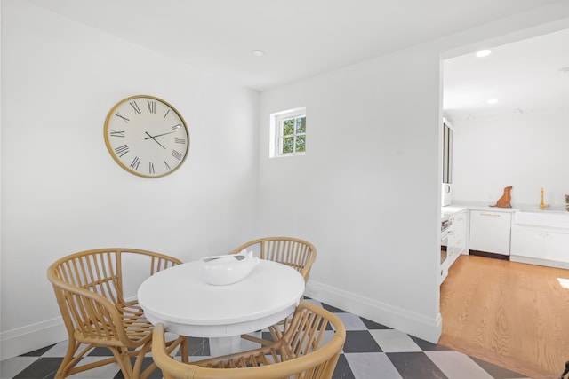 dining space with recessed lighting, baseboards, and light floors