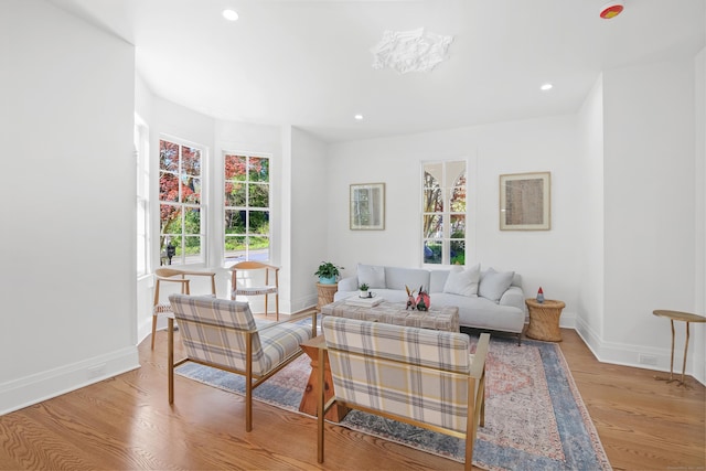 living room with recessed lighting, baseboards, and wood finished floors