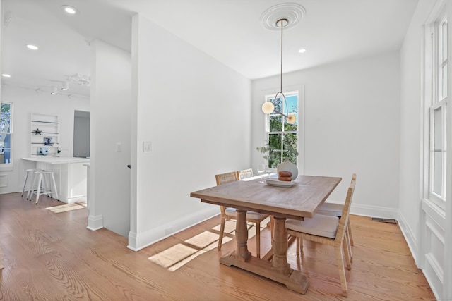 dining room with recessed lighting, light wood finished floors, baseboards, and visible vents