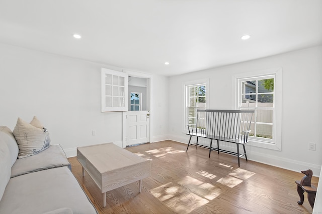 living area featuring recessed lighting, baseboards, and wood finished floors