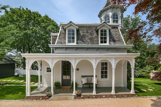 66 Seminary St, New Canaan, CT 06840 - view of front facade featuring covered porch, mansard roof, and a front yard
