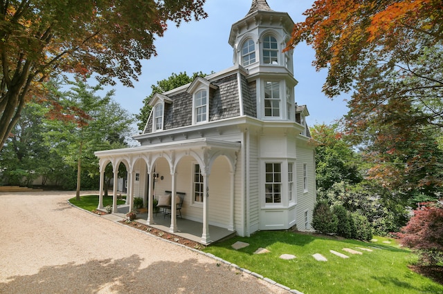 66 Seminary St, New Canaan, CT 06840 - view of front of property featuring a porch, mansard roof, and a front yard