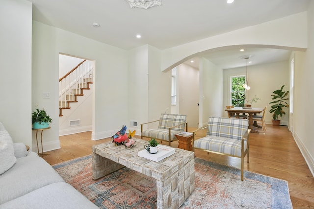 66 Seminary St, New Canaan, CT 06840 - living room with arched walkways, light wood-type flooring, recessed lighting, and stairs