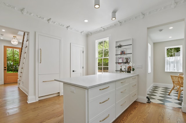 66 Seminary St, New Canaan, CT 06840 - kitchen with white cabinets, light countertops, recessed lighting, light wood-style floors, and a peninsula