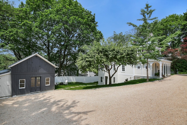 66 Seminary St, New Canaan, CT 06840 - view of side of home featuring french doors and driveway
