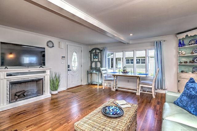 living area featuring crown molding, wood finished floors, a fireplace, baseboards, and beam ceiling