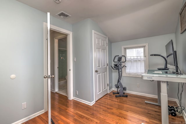 workout room with baseboards, wood finished floors, visible vents, and vaulted ceiling