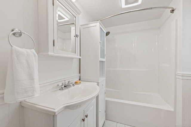 bathroom featuring tub / shower combination, tile patterned flooring, and vanity