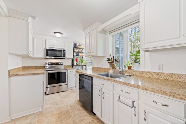 kitchen featuring a sink, light countertops, stainless steel appliances, and white cabinetry