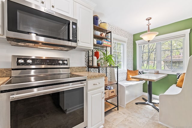 kitchen with pendant lighting, open shelves, stainless steel appliances, and white cabinetry