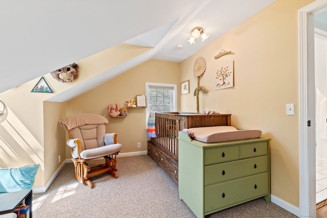 bedroom featuring baseboards, light colored carpet, and vaulted ceiling