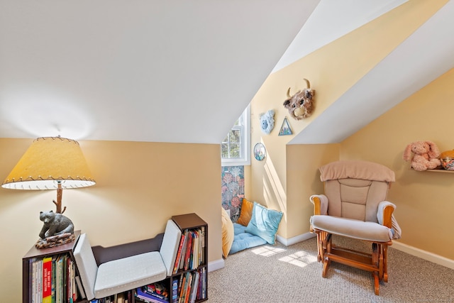living area with carpet floors, baseboards, and lofted ceiling