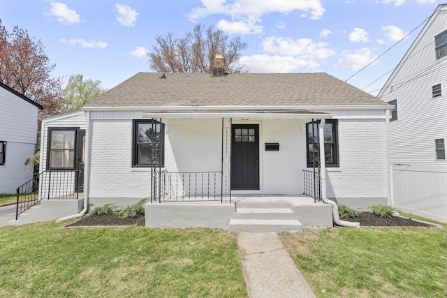 449 High St, Fairfield, CT 06824 - bungalow with a front lawn, a chimney, and brick siding