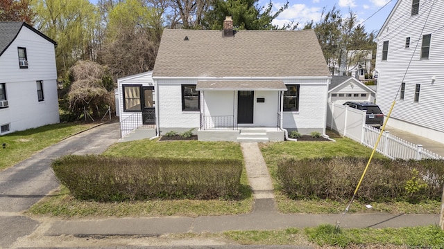 449 High St, Fairfield, CT 06824 - bungalow-style house with fence, a chimney, roof with shingles, and brick siding