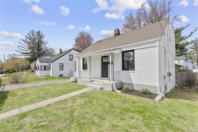 449 High St, Fairfield, CT 06824 - bungalow-style house featuring a shingled roof, a front lawn, a chimney, and brick siding