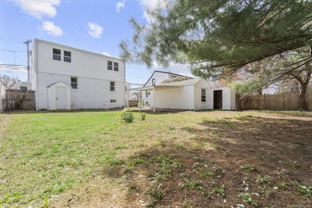 449 High St, Fairfield, CT 06824 - rear view of property with fence, a lawn, an outdoor structure, and a storage shed