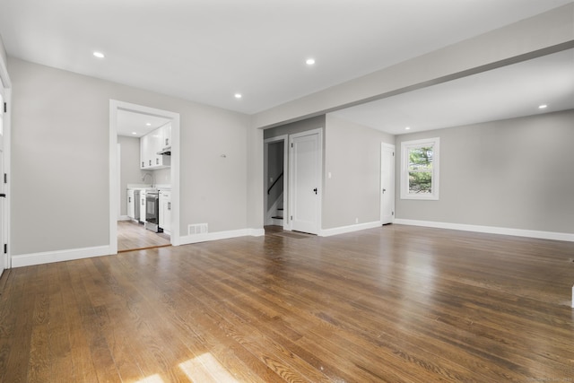 449 High St, Fairfield, CT 06824 - unfurnished living room with stairway, wood finished floors, baseboards, visible vents, and recessed lighting