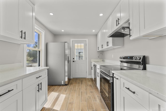 449 High St, Fairfield, CT 06824 - kitchen with a sink, stainless steel appliances, white cabinets, under cabinet range hood, and recessed lighting