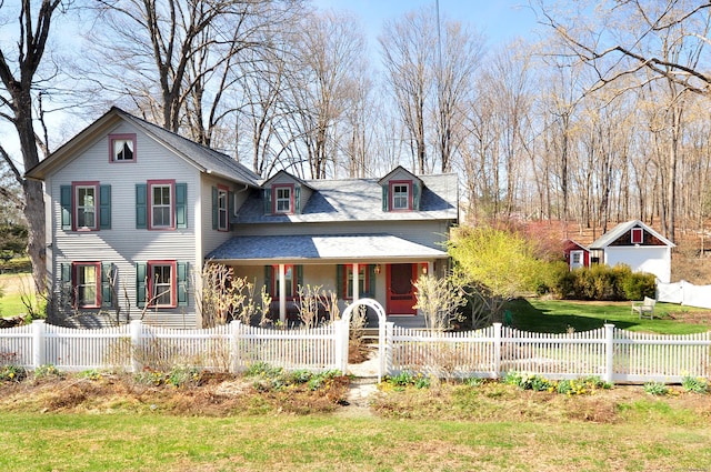 victorian house featuring a fenced front yard and covered porch